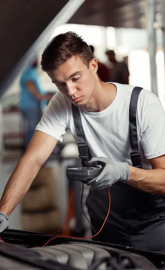 an-attractive-car-mechanic-is-checking-the-results-of-his-work-at-a-car-repair-service